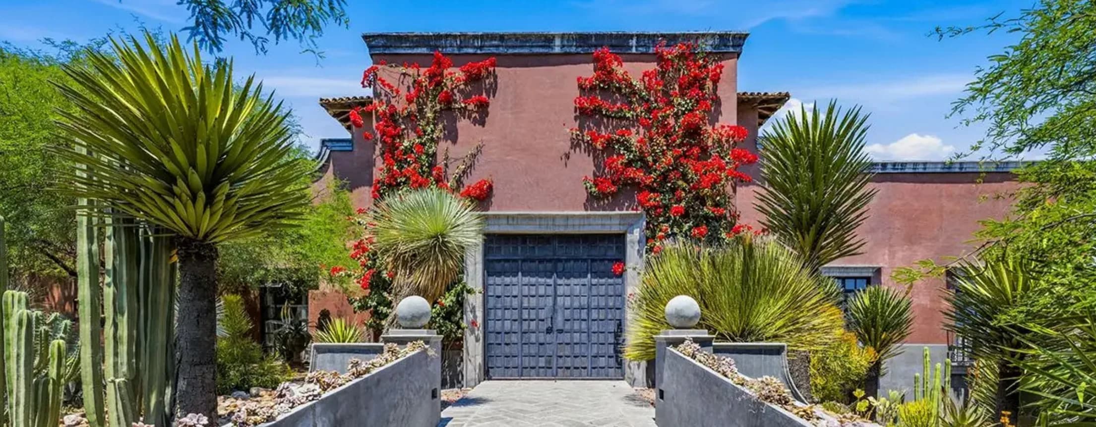 A colonial home in San Miguel de Allende framed by red bougainvillea