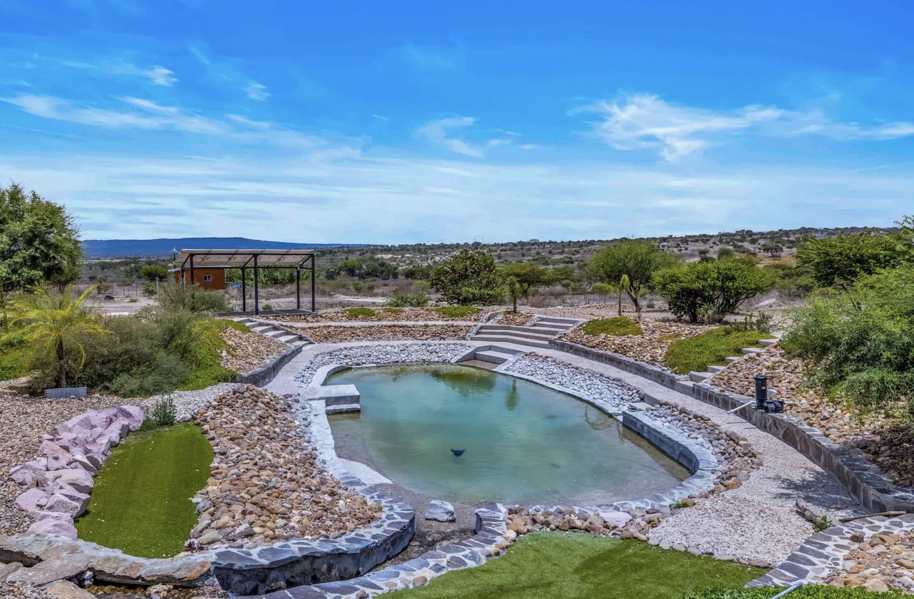 Natural pool and landscaped grounds on the property