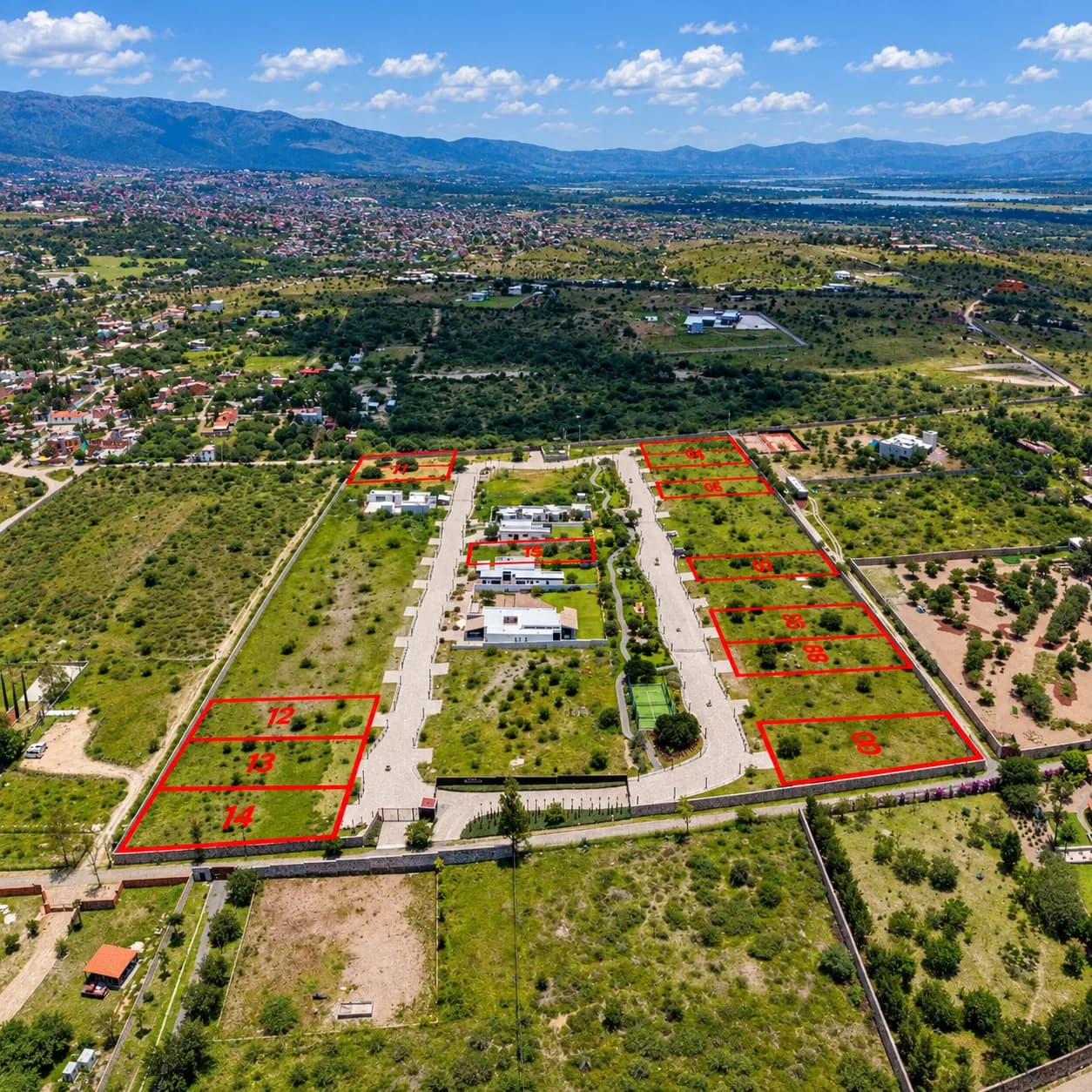 Aerial photo of Mítico with available homesites outlined and numbered, San Miguel de Allende visible in the distance