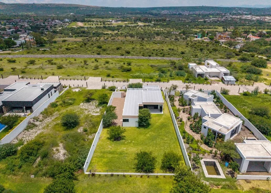 Aerial view of modern single-level Mítico homes on spacious green lots in the San Miguel de Allende countryside