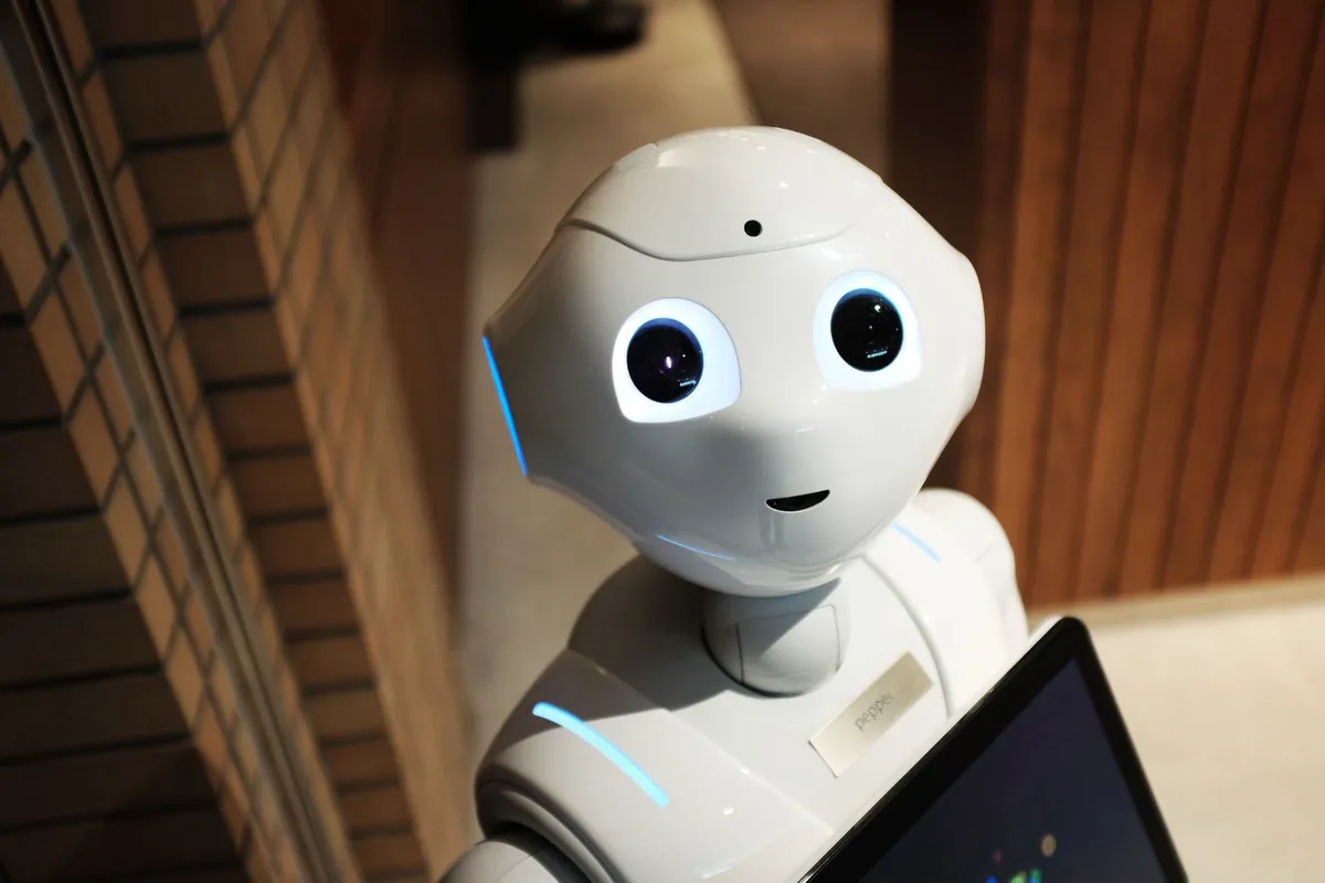 A humanoid AI robot holding a tablet